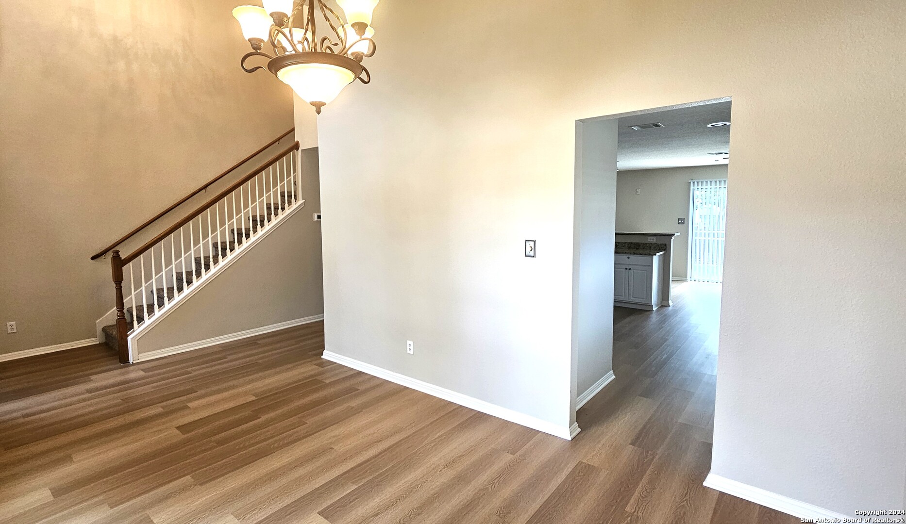 209 Storm Mt Road Cibolo, TX 78108 - Photo 10 of 28 a view of a hallway with wooden floor and staircase