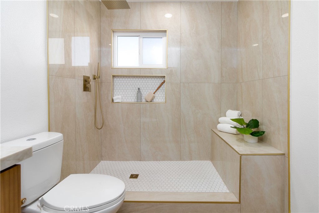 3306 Debbie Lane Riverside, CA 92501 - Photo 24 of 32 a white toilet sitting next to a bath tub