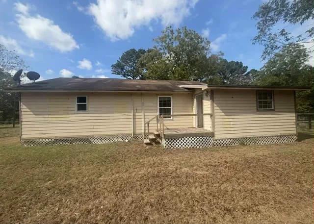 a side view of a house with a yard