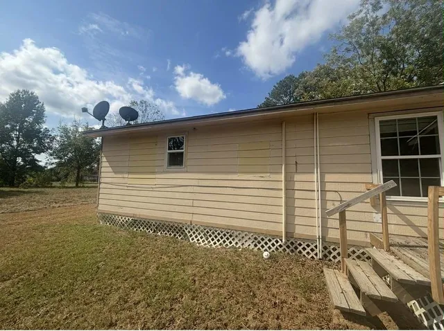 a back view of a house with a yard