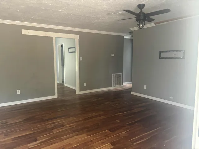 a view of an empty room and wooden floor