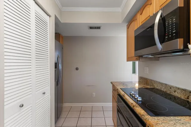 a kitchen with granite countertop a sink and a window