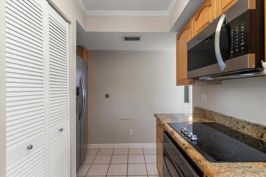 18201 Gulf Boulevard, Unit 401 Redington Shores, FL 33708 - Photo 11 of 42 a kitchen with a stove and a microwave