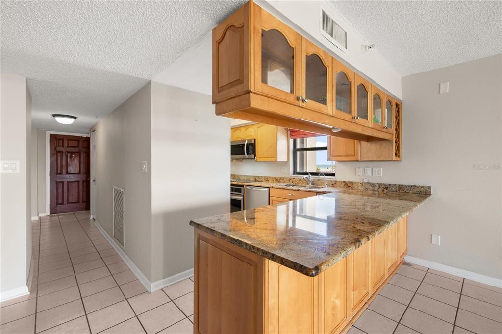 18201 Gulf Boulevard, Unit 401 Redington Shores, FL 33708 - Photo 13 of 42 a kitchen with a sink a counter top space and cabinets