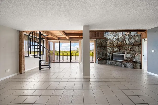 a kitchen with granite countertop a refrigerator and a stove top oven