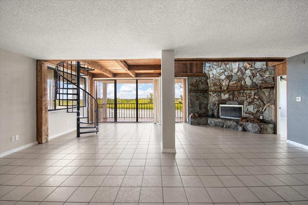 18201 Gulf Boulevard, Unit 401 Redington Shores, FL 33708 - Photo 16 of 42 an empty room with floor to ceiling window and outdoor seating