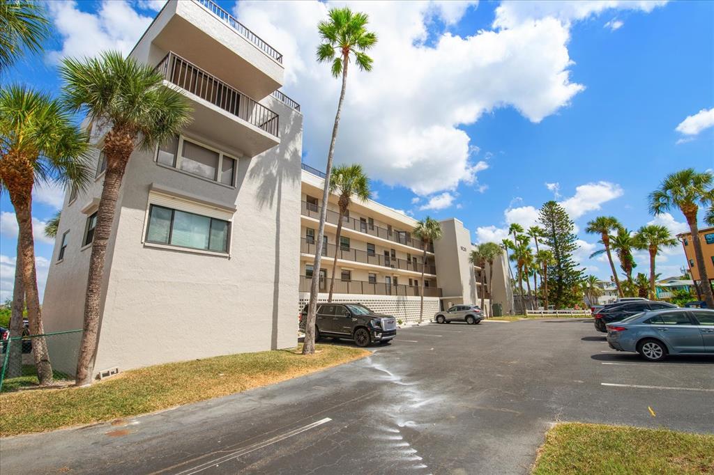 18201 Gulf Boulevard, Unit 401 Redington Shores, FL 33708 - Photo 2 of 42 a view of a street that has couple of cars parked on the road