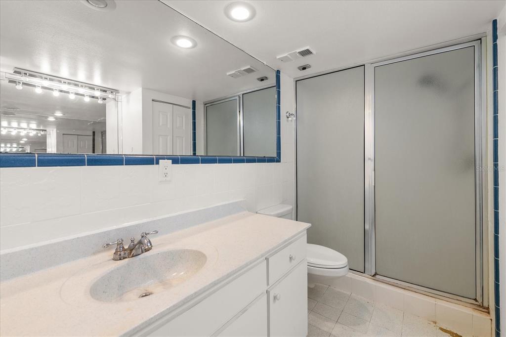 18201 Gulf Boulevard, Unit 401 Redington Shores, FL 33708 - Photo 25 of 42 a bathroom with a sink toilet and shower