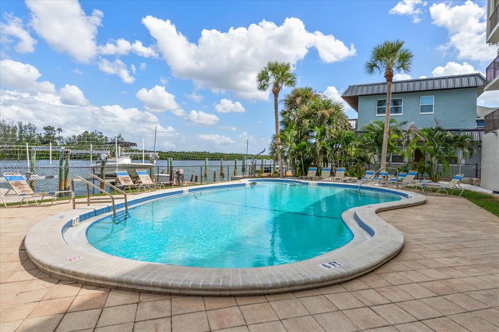 18201 Gulf Boulevard, Unit 401 Redington Shores, FL 33708 - Photo 38 of 42 a view of a swimming pool with outdoor seating