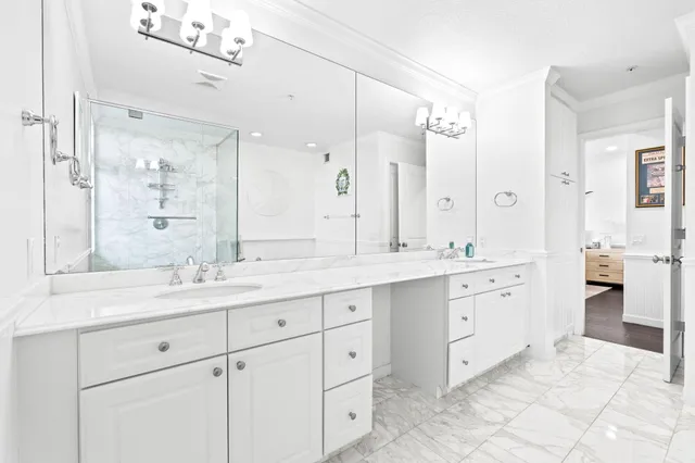 a spacious bathroom with double sink and a mirror
