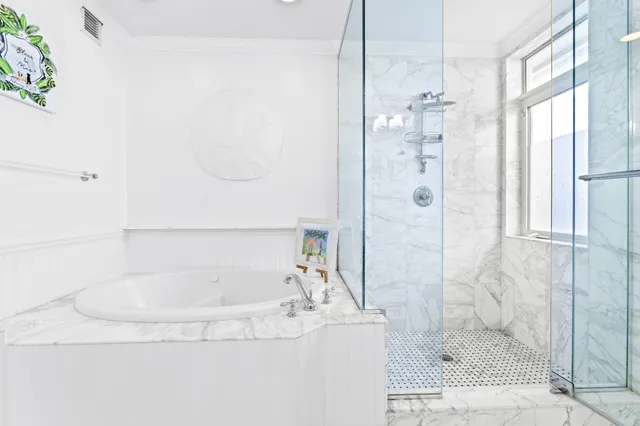 a bathroom with a bathtub and shower
