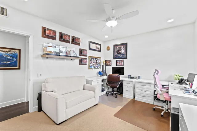 a living room with furniture and a work place area