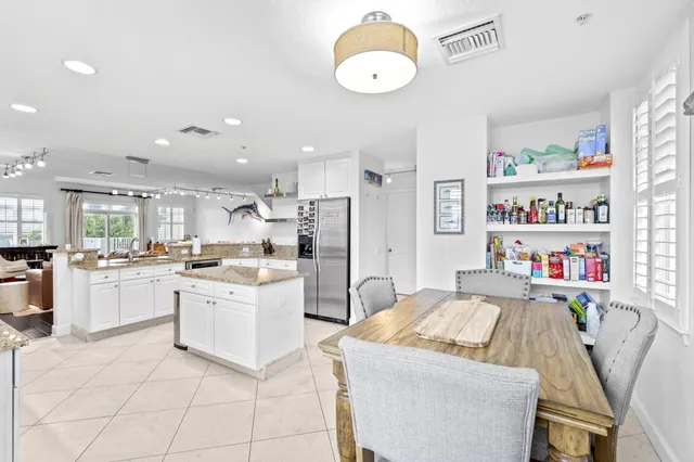 a large white kitchen with a lot of white cabinets
