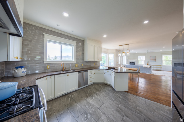 868 Braddock Lane Alpine, UT 84004 - Photo 16 of 64 Modern kitchen featuring white cabinetry, a gray subway tile backsplash, dark countertops, and stainless steel appliances