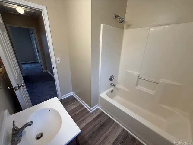 a bathroom with a bathtub and a sink