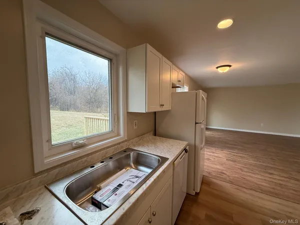 a kitchen with a stove a sink and a window