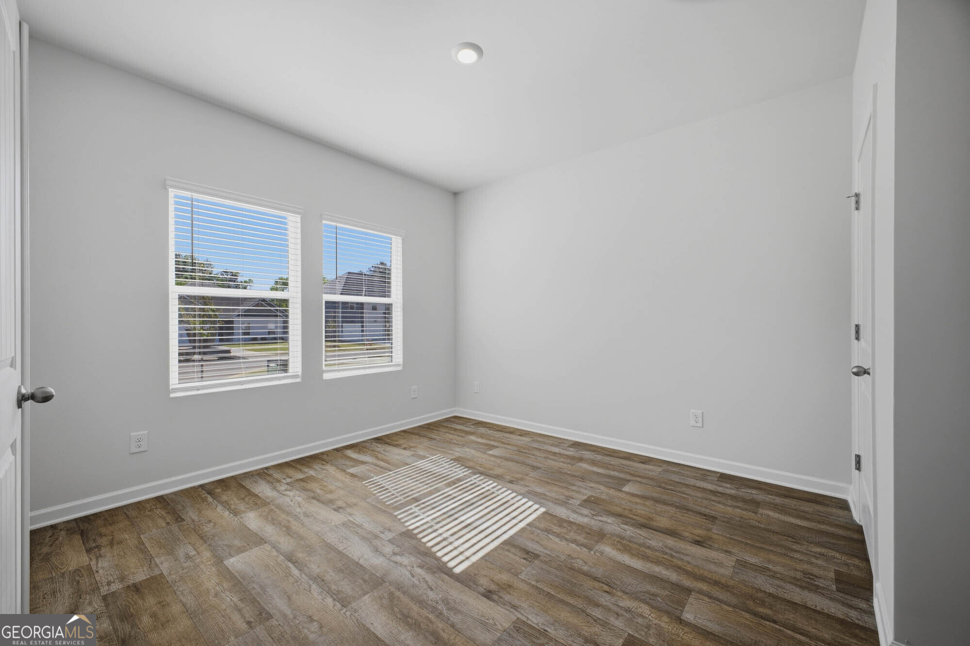 309 Rusty Plow Lane Perry, GA 31069 - Photo 16 of 34 a view of an empty room with wooden floor and a window