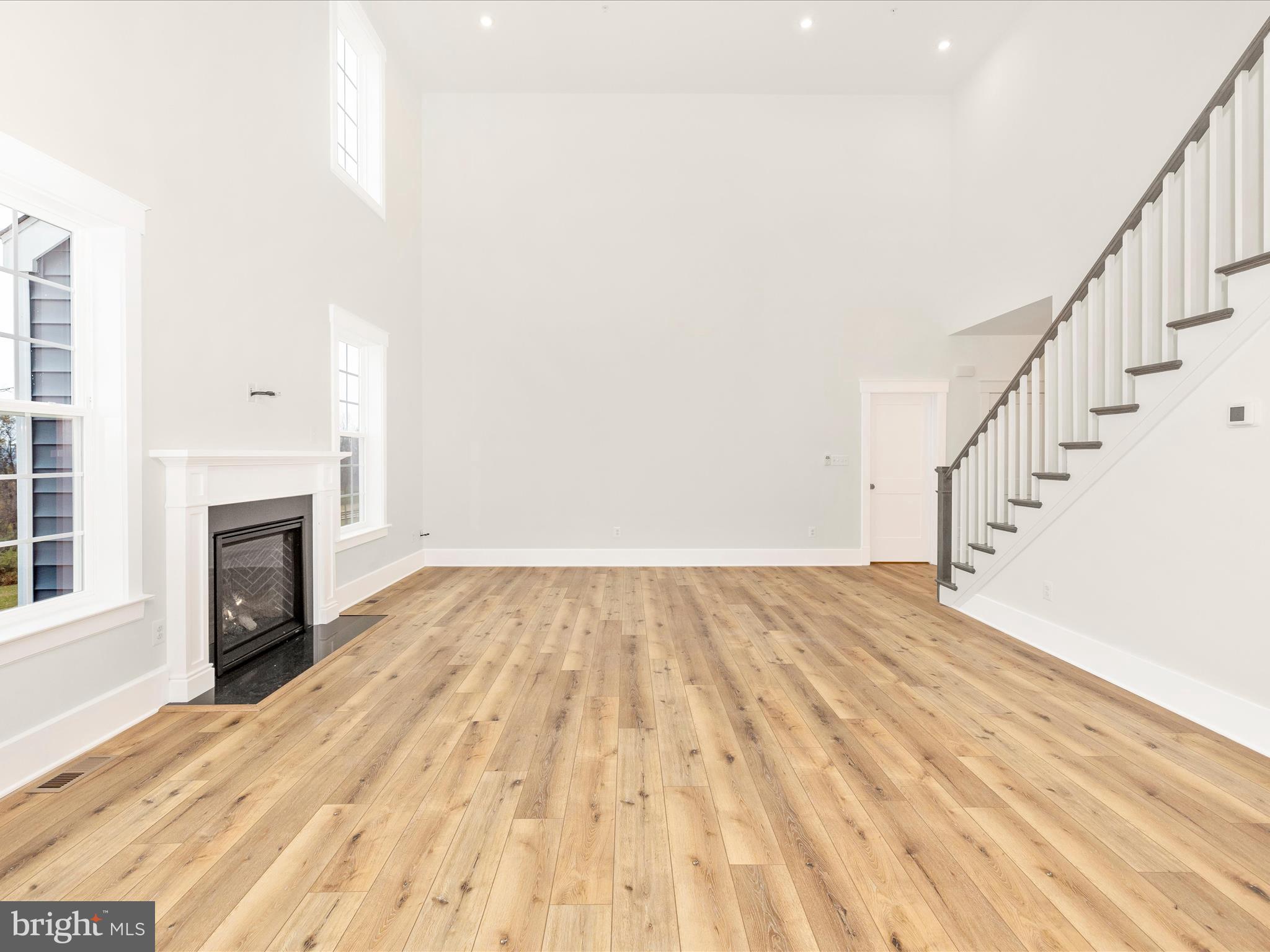 7022 Ridge Road Frederick, MD 21702 - Photo 12 of 63 a view of empty room with wooden floor and fireplace