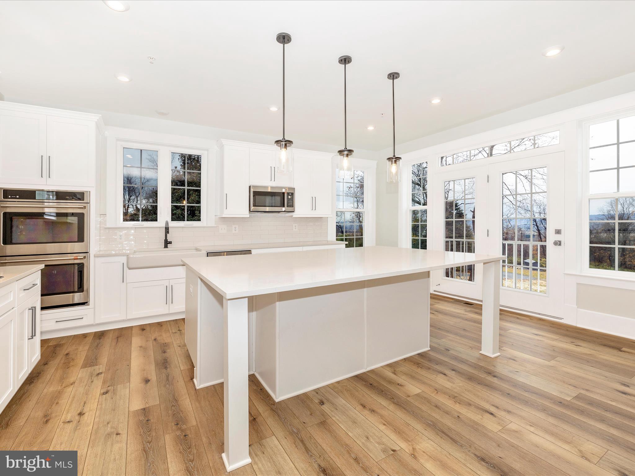 7022 Ridge Road Frederick, MD 21702 - Photo 20 of 63 a view of kitchen with stainless steel appliances kitchen island wooden floor and window