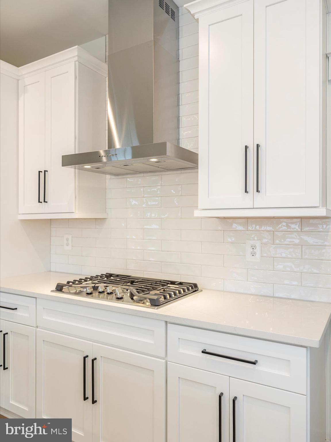 7022 Ridge Road Frederick, MD 21702 - Photo 27 of 63 a kitchen with white cabinets and appliances