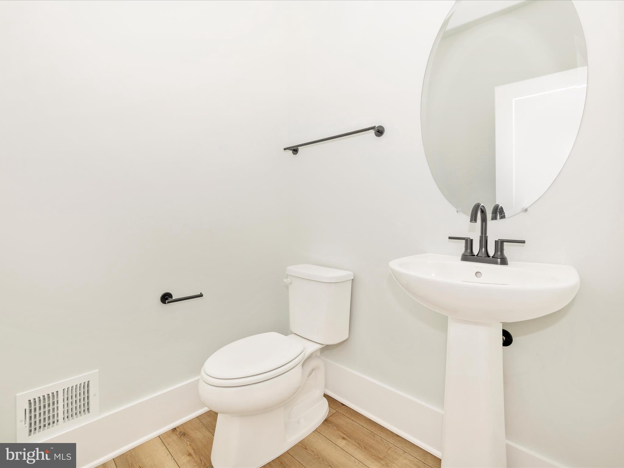 7022 Ridge Road Frederick, MD 21702 - Photo 29 of 63 a bathroom with a sink a toilet and mirror