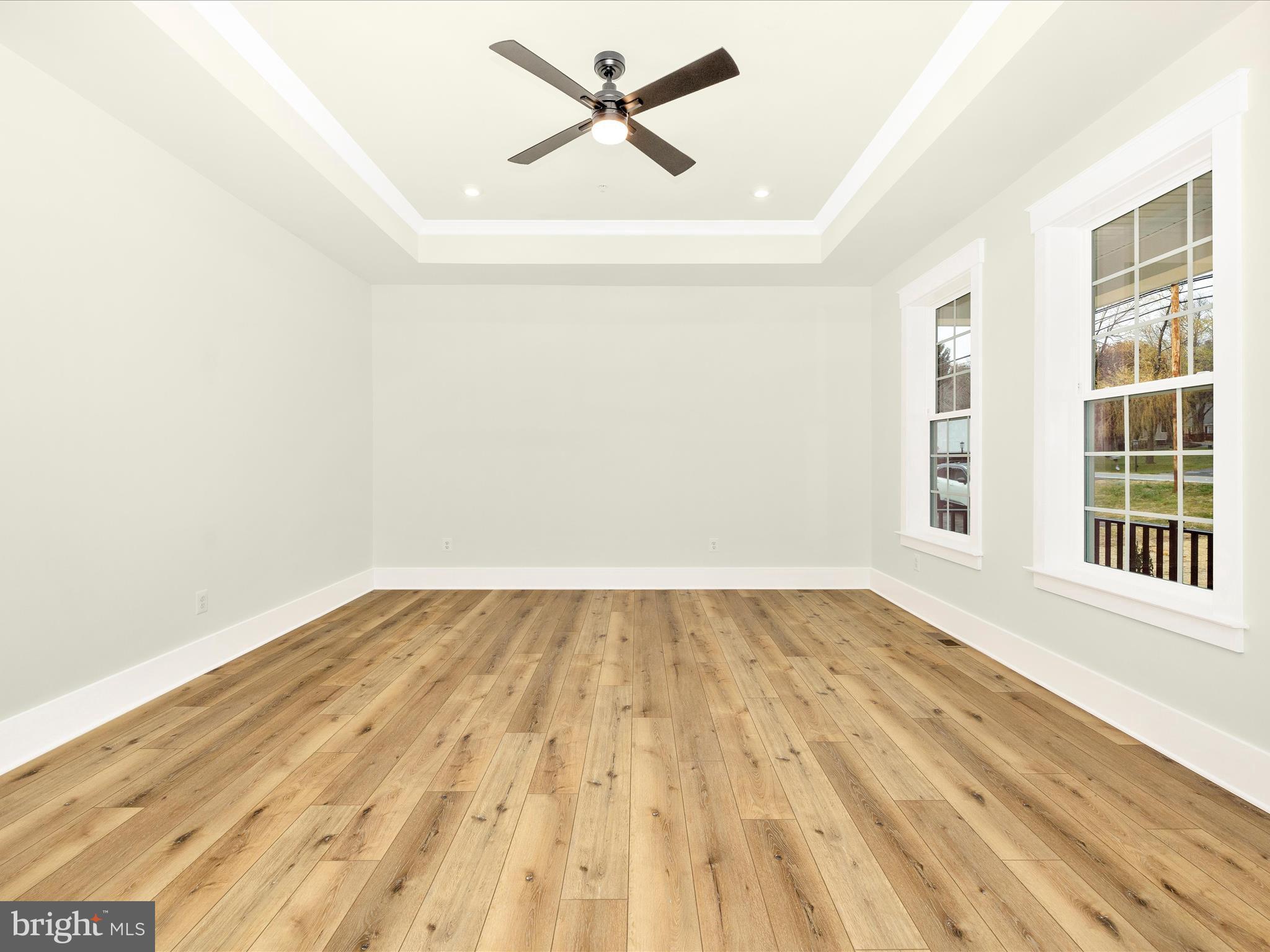 7022 Ridge Road Frederick, MD 21702 - Photo 33 of 63 an empty room with wooden floor fan and windows