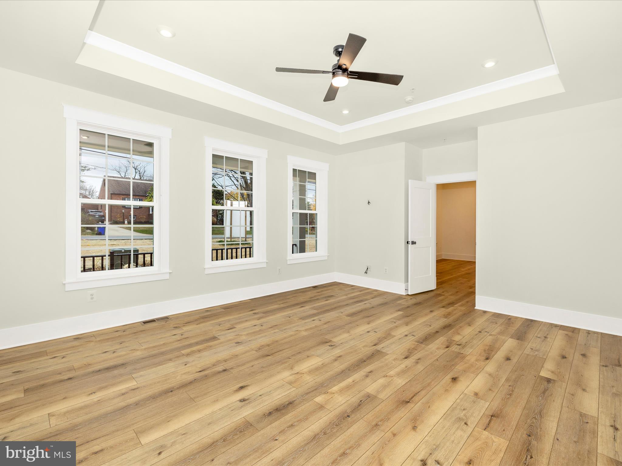 7022 Ridge Road Frederick, MD 21702 - Photo 34 of 63 a view of empty room with wooden floor and windows