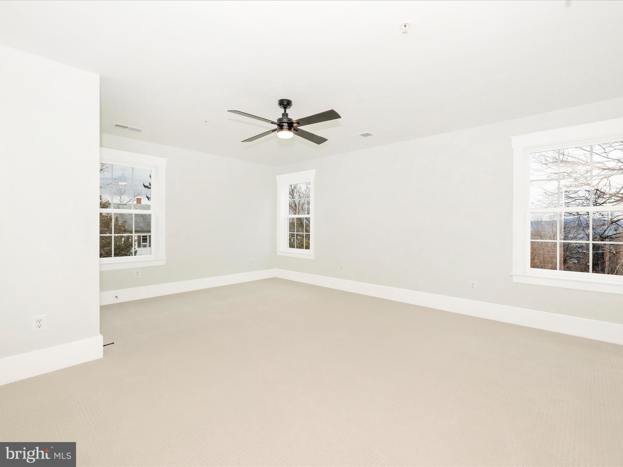 7022 Ridge Road Frederick, MD 21702 - Photo 43 of 63 an empty room with windows and ceiling fan