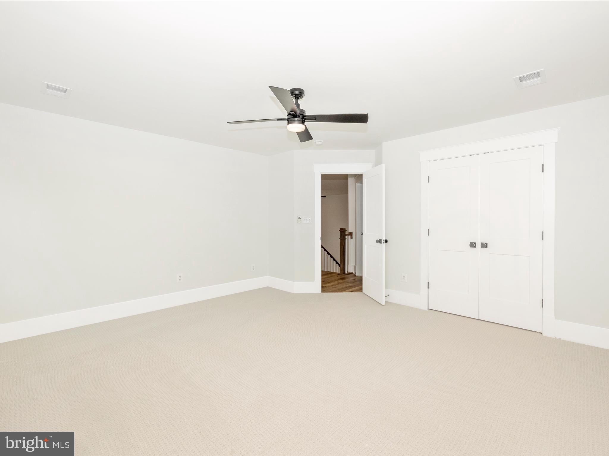 7022 Ridge Road Frederick, MD 21702 - Photo 46 of 63 an empty room with a ceiling fan and a window