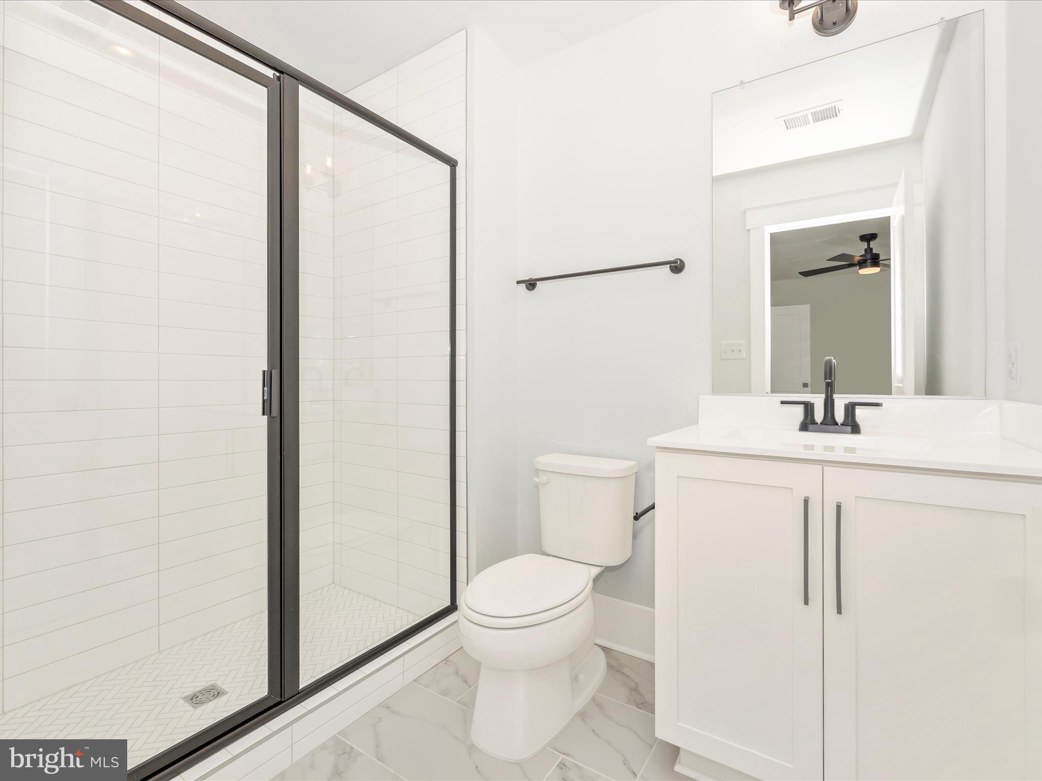 7022 Ridge Road Frederick, MD 21702 - Photo 50 of 63 a bathroom with a toilet a sink and a mirror