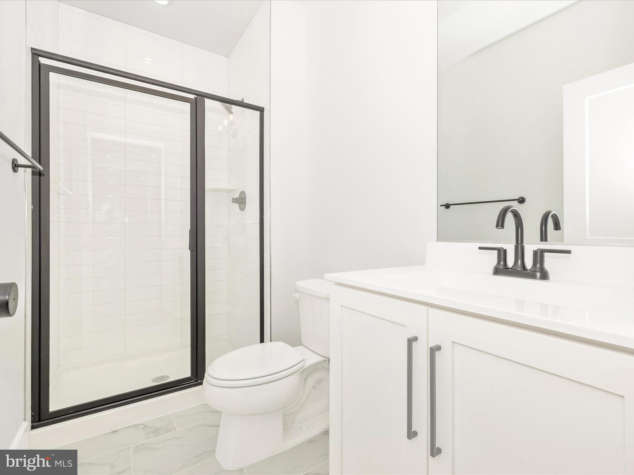 7022 Ridge Road Frederick, MD 21702 - Photo 56 of 63 a bathroom with a sink a toilet a mirror and shower