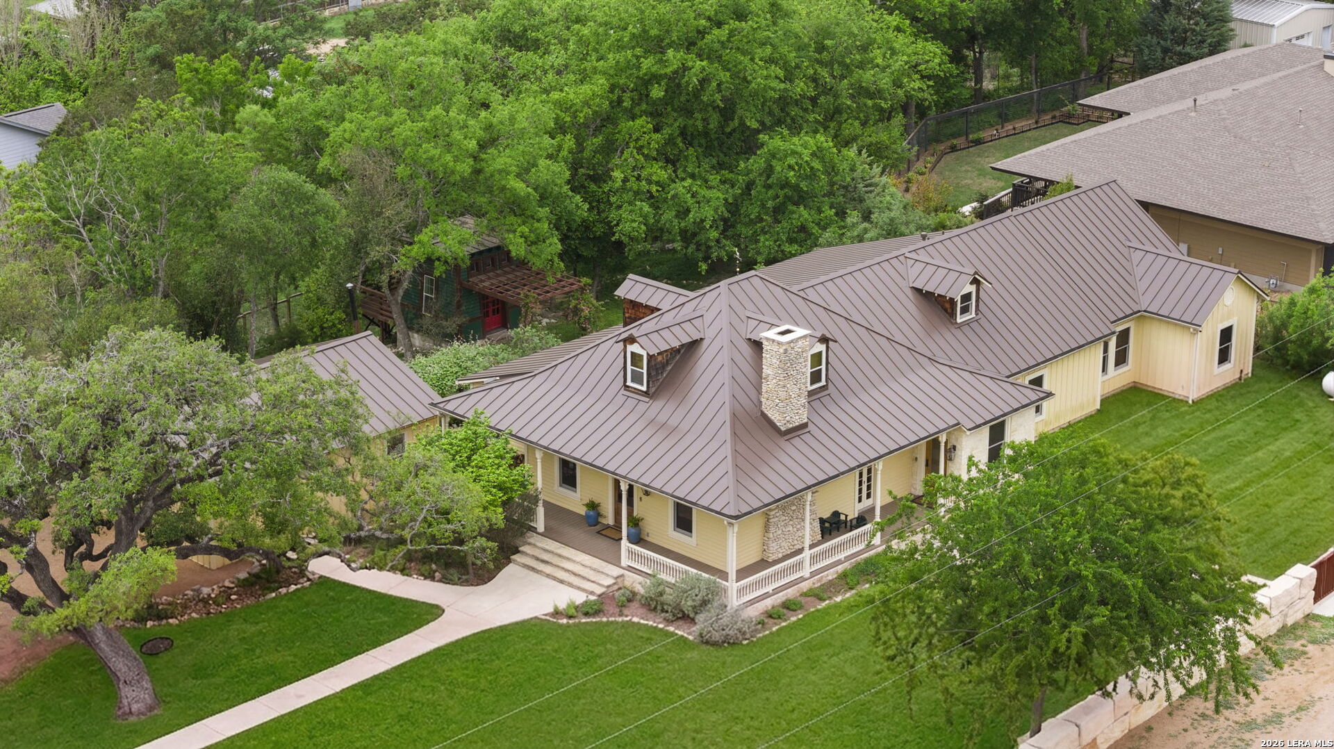 107 High Street Comfort, TX 78013 - Photo 2 of 50 a view of a house with a big yard and large trees