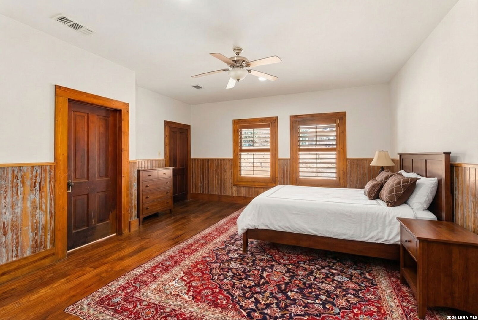107 High Street Comfort, TX 78013 - Photo 28 of 50 a bedroom with a large bed and a chandelier
