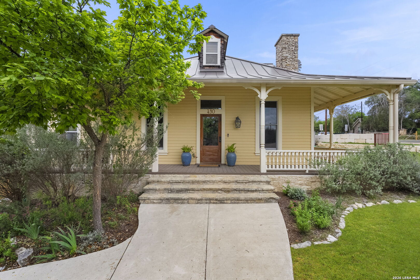 107 High Street Comfort, TX 78013 - Photo 9 of 50 a front view of a house with garden
