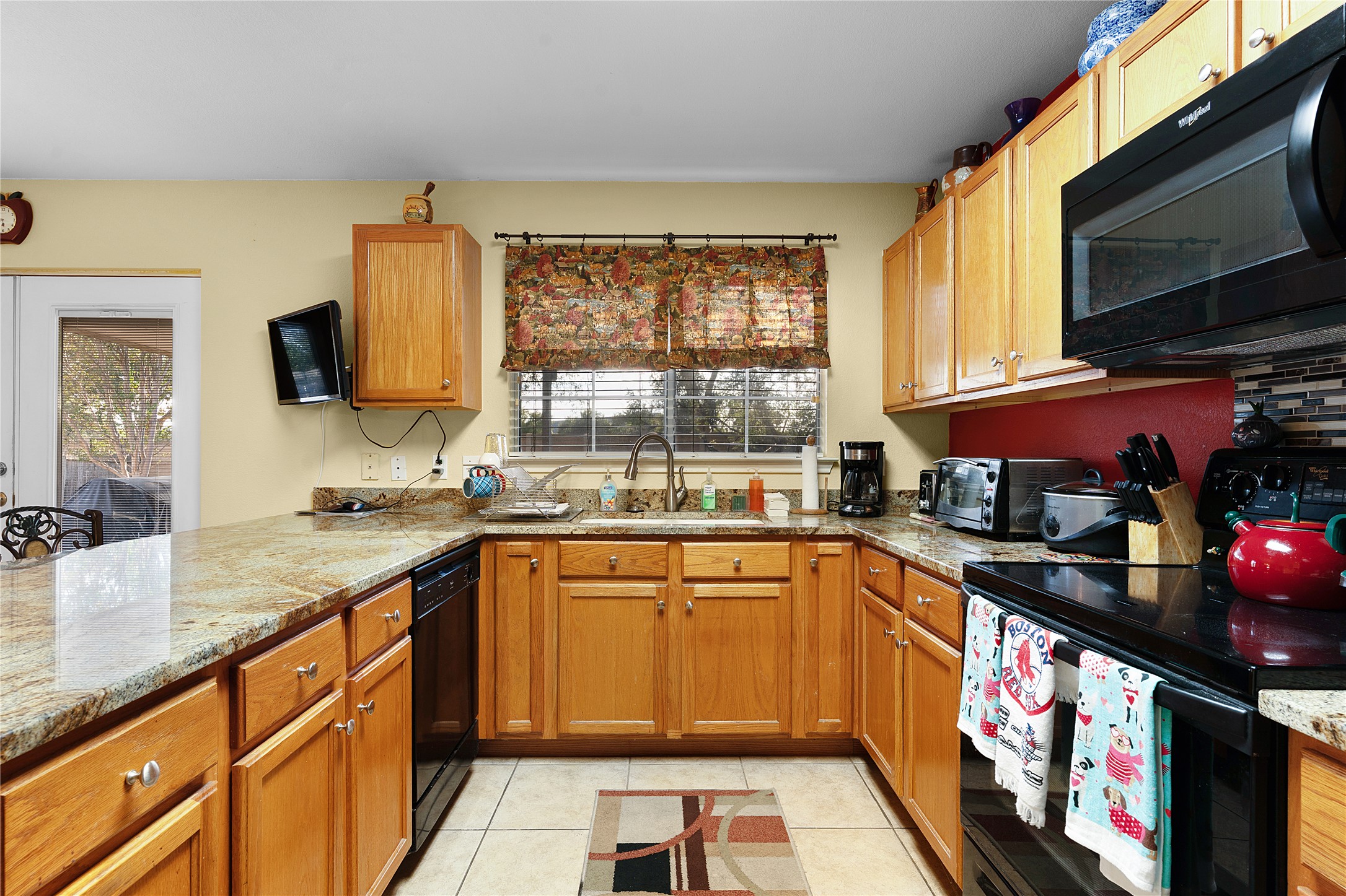 2305 Little Tree Bend Cedar Park, TX 78613 - Photo 15 of 40 a kitchen with stainless steel appliances granite countertop a sink and a stove top oven