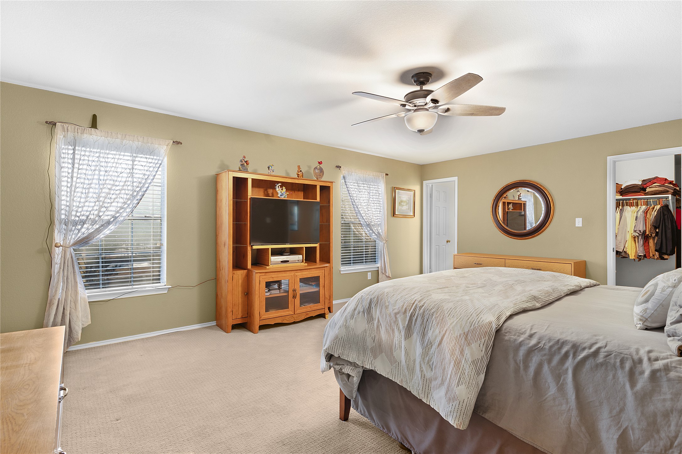 2305 Little Tree Bend Cedar Park, TX 78613 - Photo 29 of 40 a bedroom with a bed and a flat tv screen on dresser