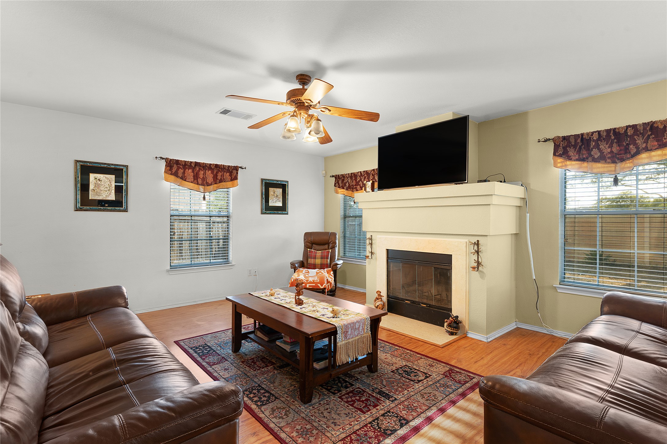 2305 Little Tree Bend Cedar Park, TX 78613 - Photo 10 of 40 a living room with furniture a flat screen tv and a fireplace