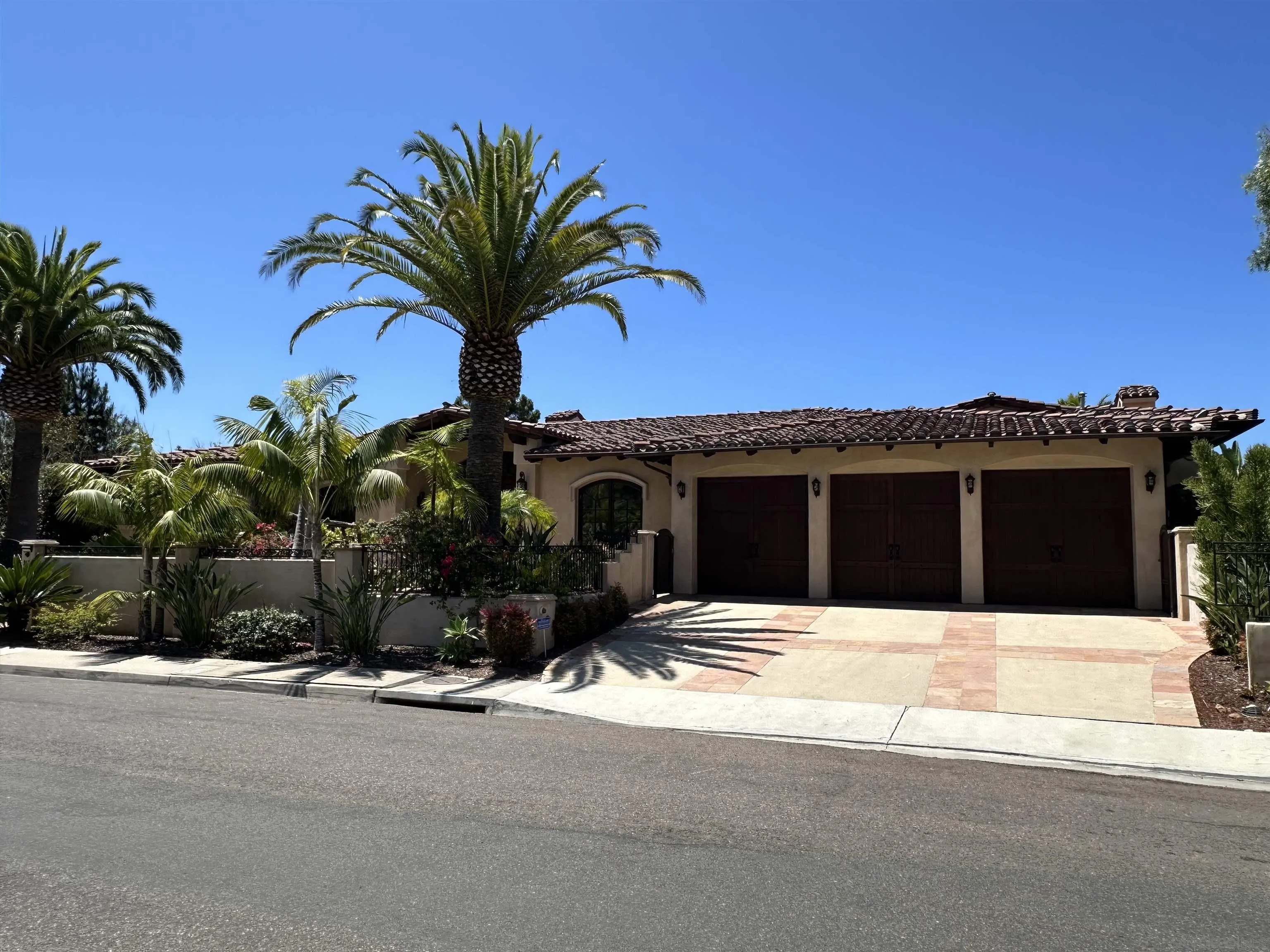 8656 Glenwick Lane La Jolla, CA 92037 - Photo 1 of 2 a view of a house with a yard and garage