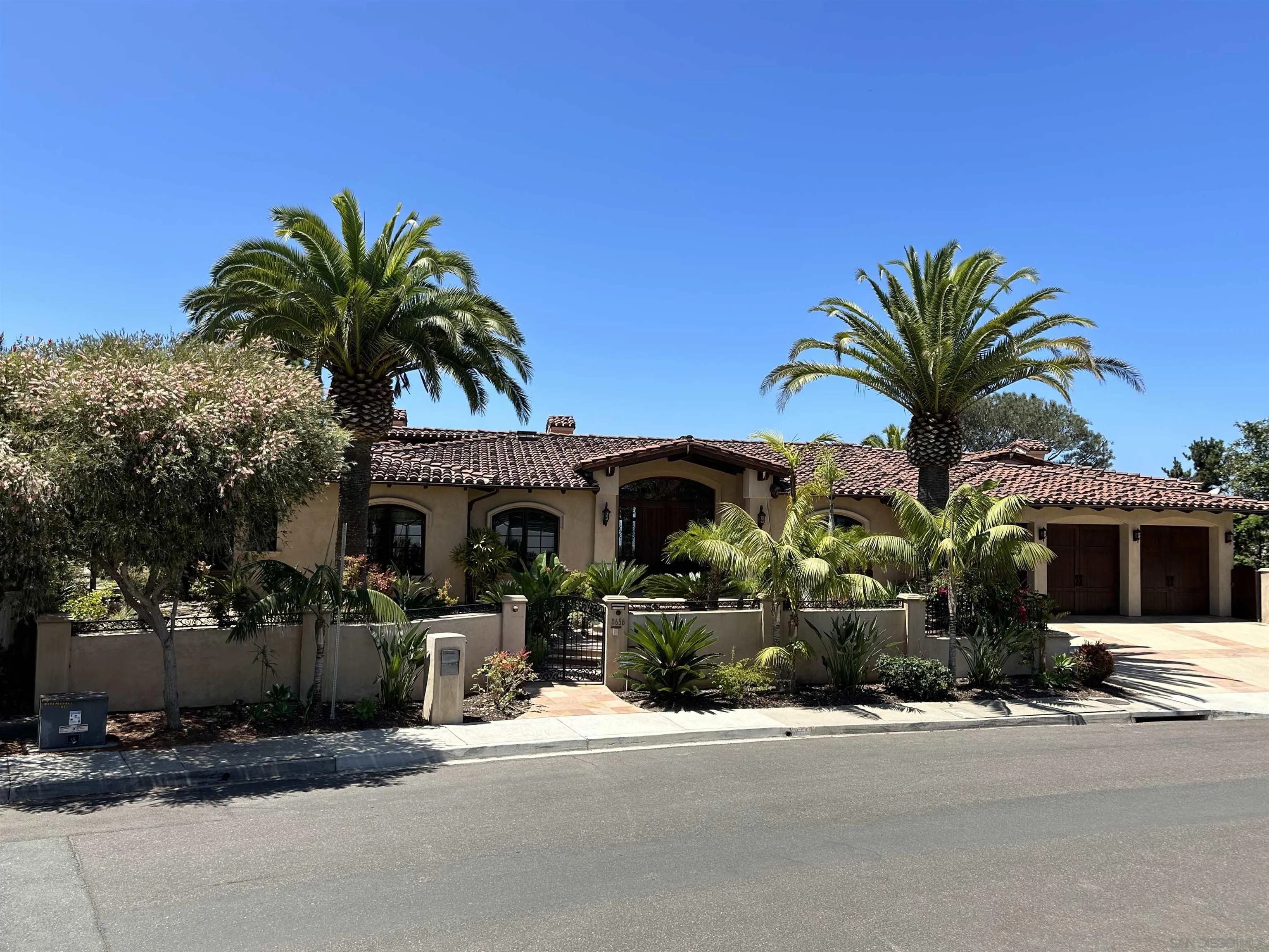 8656 Glenwick Lane La Jolla, CA 92037 - Photo 2 of 2 a front view of a house with a yard and garage