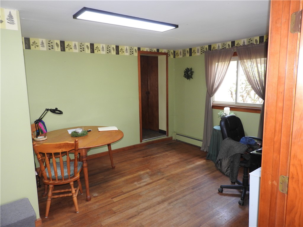2185 East Loy Road Piqua, OH 45356 - Photo 5 of 19 This versatile room features warm wood flooring and a bright window, perfect for various uses.