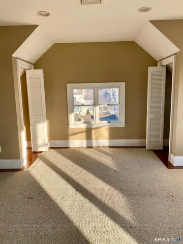 a view of a livingroom with wooden floor and a window
