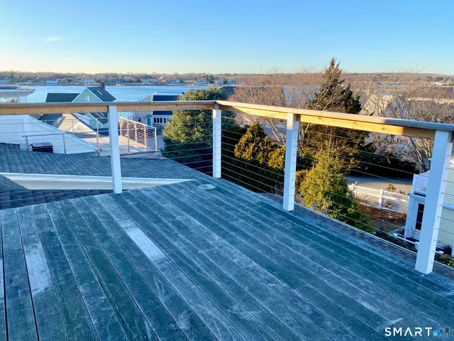 a view of a balcony with furniture and wooden floor