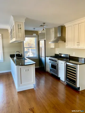 a kitchen with granite countertop a stove and a sink