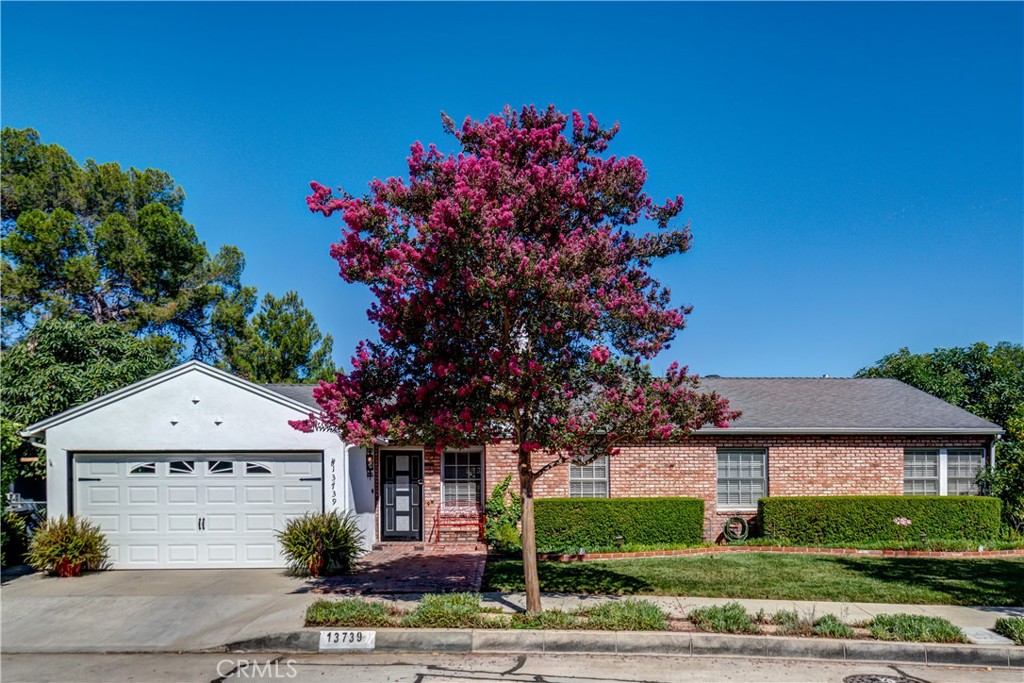 13739 Ridge Road Whittier, CA 90601 - Photo 1 of 42 a front view of a house with a garden