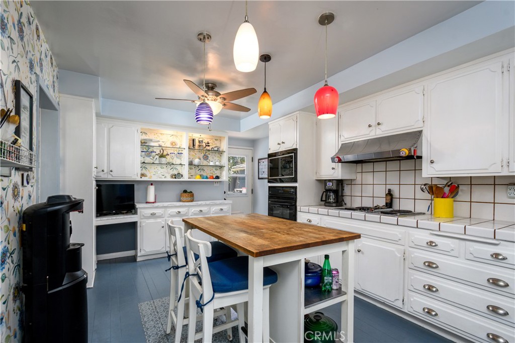 13739 Ridge Road Whittier, CA 90601 - Photo 12 of 42 a kitchen with stainless steel appliances kitchen island granite countertop a table chairs and a refrigerator