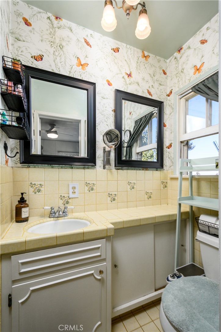 13739 Ridge Road Whittier, CA 90601 - Photo 15 of 42 a bathroom with a sink a toilet and a mirror