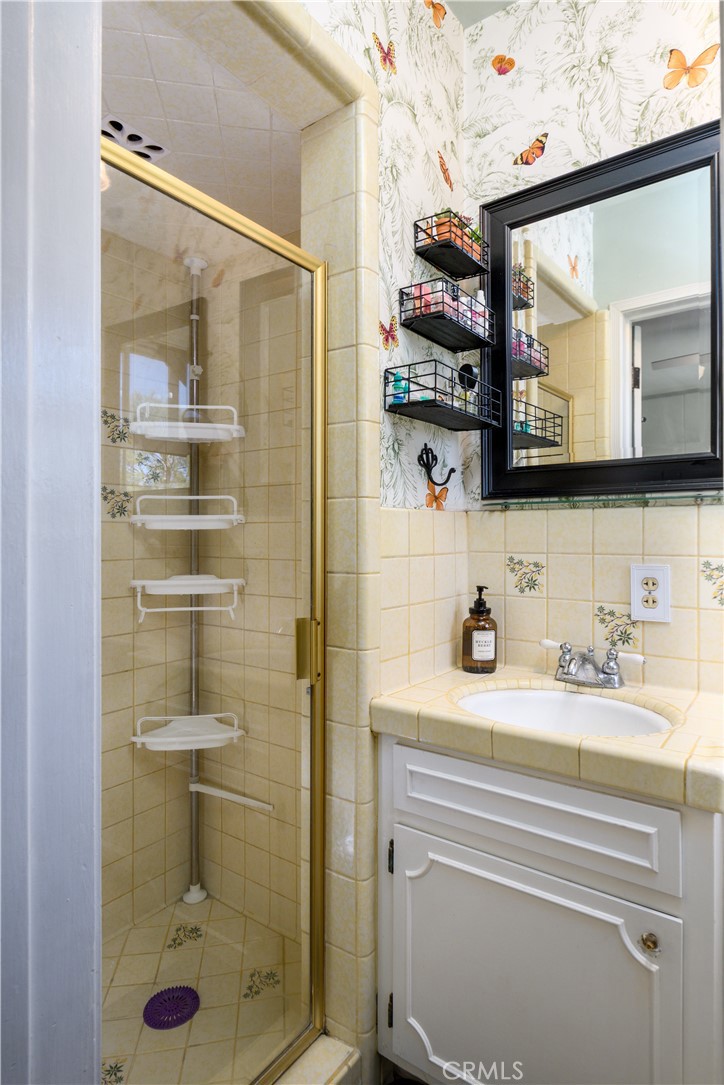 13739 Ridge Road Whittier, CA 90601 - Photo 16 of 42 a bathroom with a shower sink and mirror
