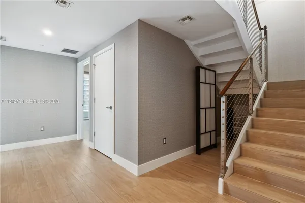 a view of entryway with wooden floor