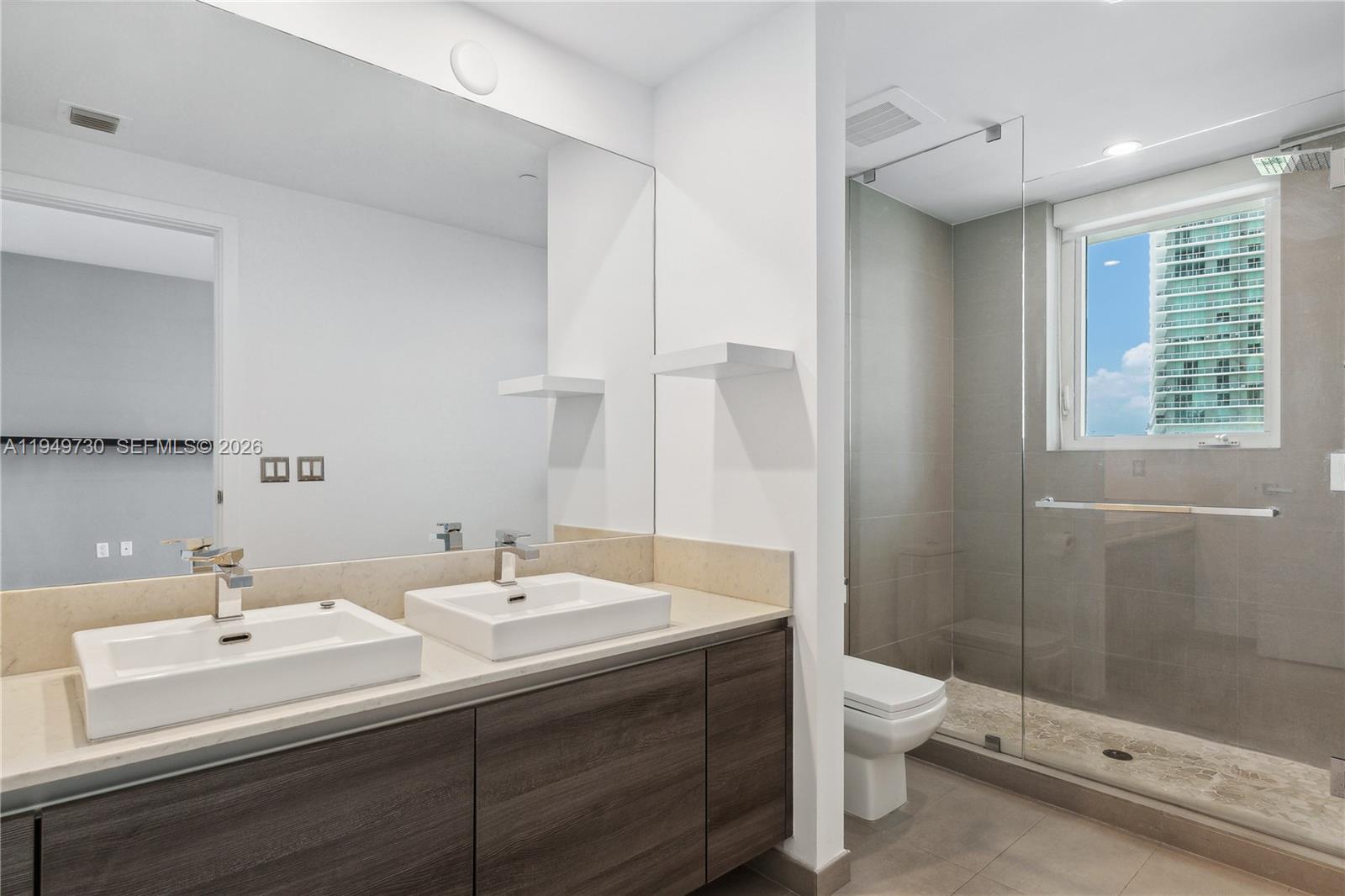 1080 Brickell Avenue, Unit 1401 Miami, FL 33131 - Photo 23 of 27 a bathroom with a sink a toilet and shower