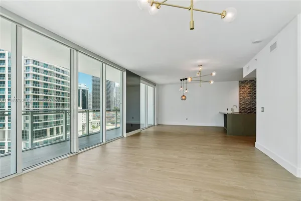 a view of an empty room with glass door